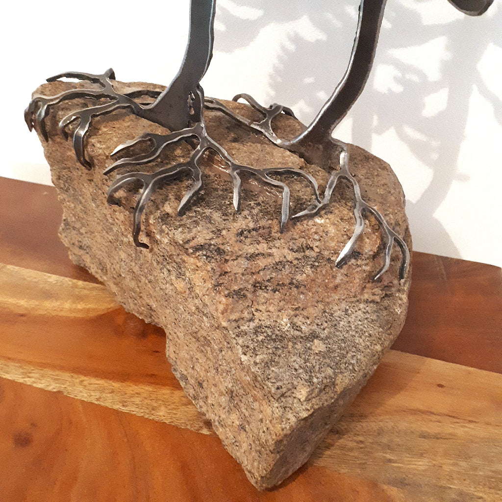 Tree cut from metal and mounted on a piece of Canadian granite - root detail