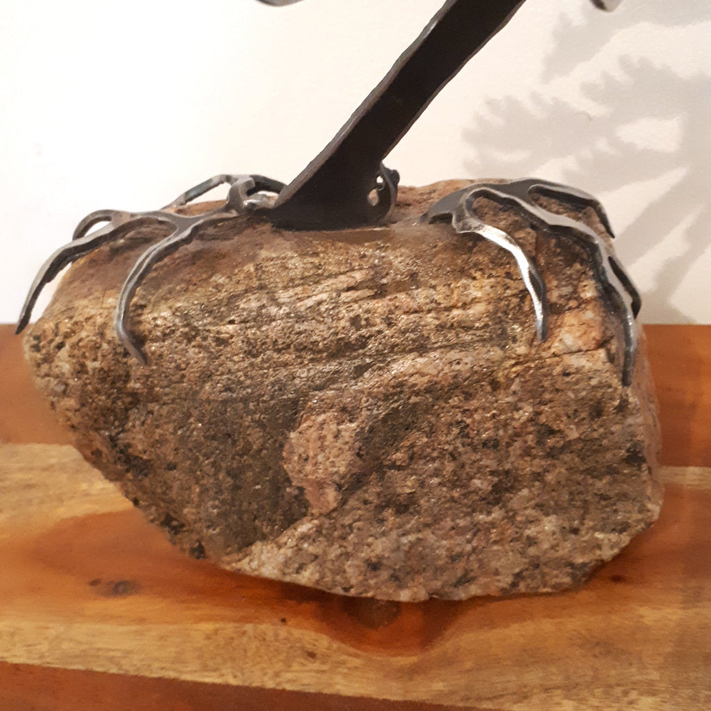 rock detail of metal tree sculpture