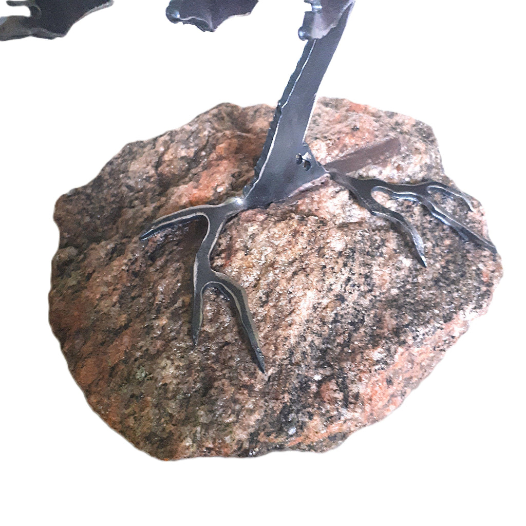 rock and root detail of a metal tree sculpture