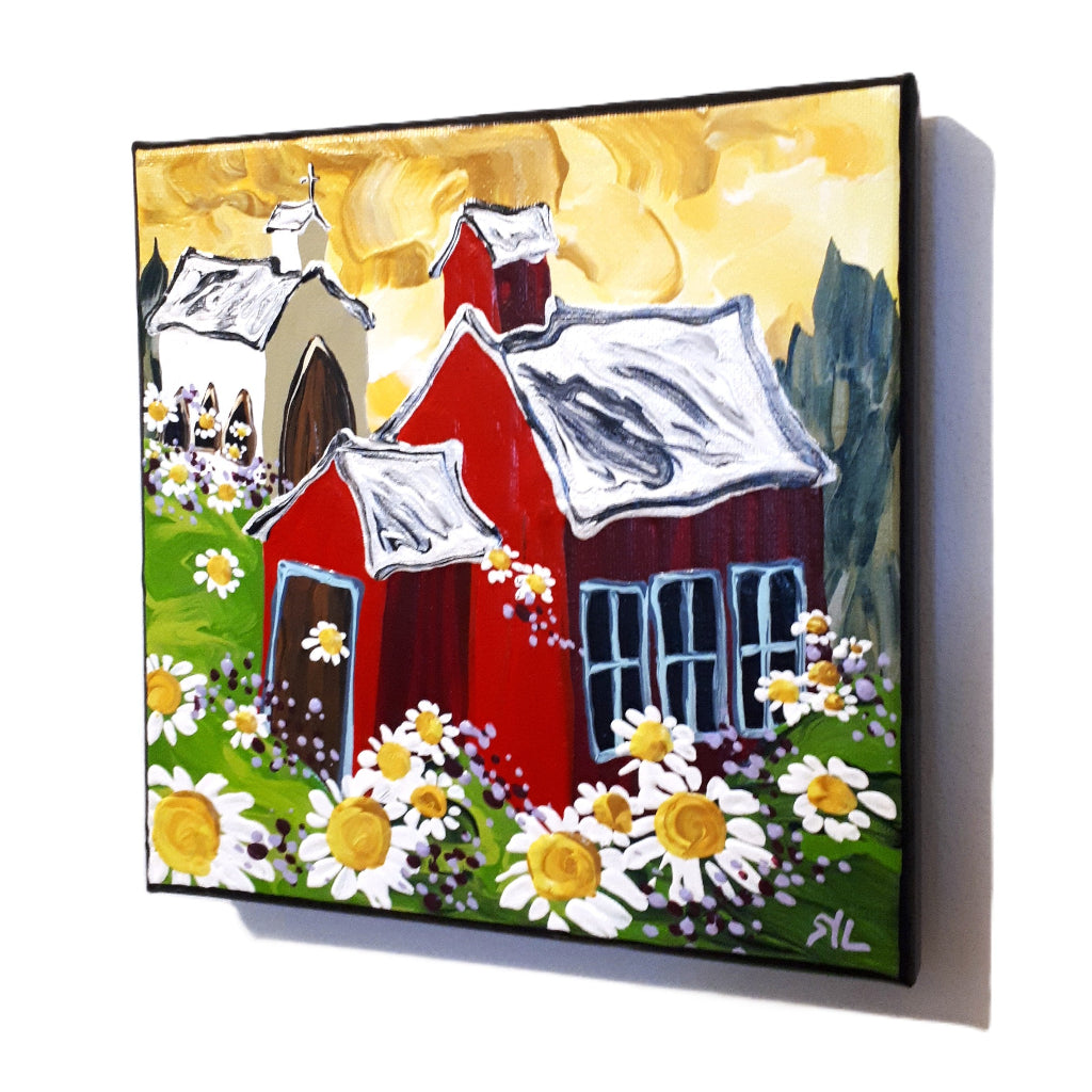 Painting of a red schoolhouse and white church with white roofs surrounded by flowers and greenery.