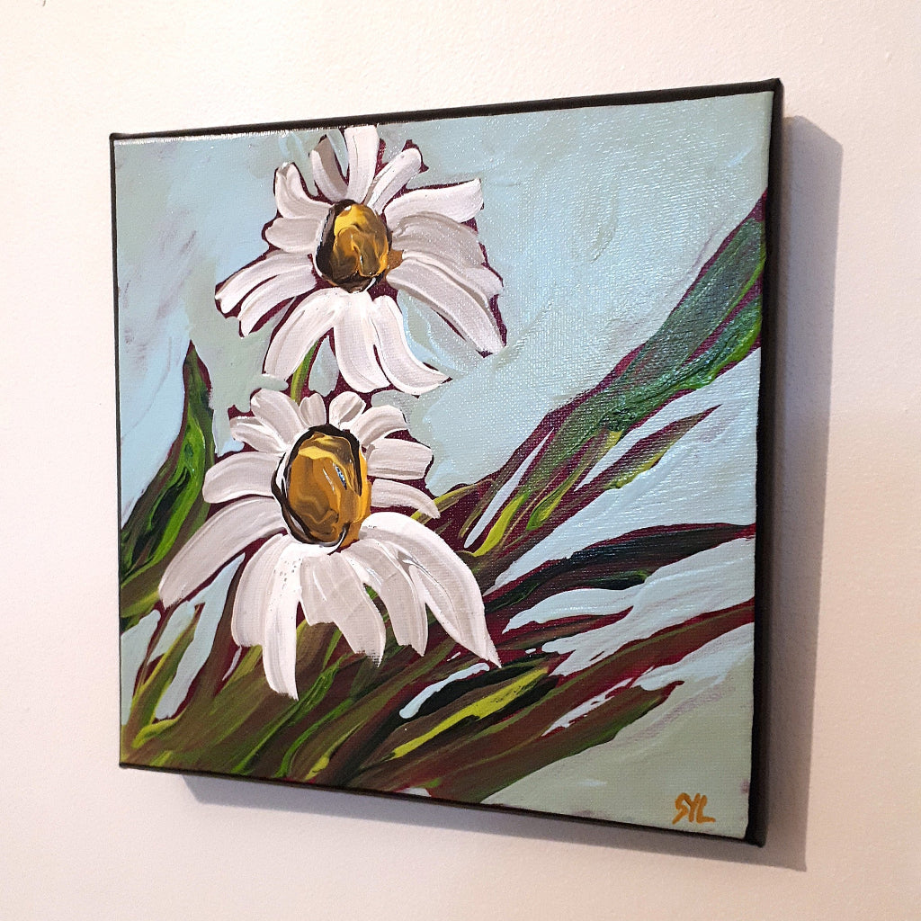 Painting of two daisies with green leaves on a light blue background