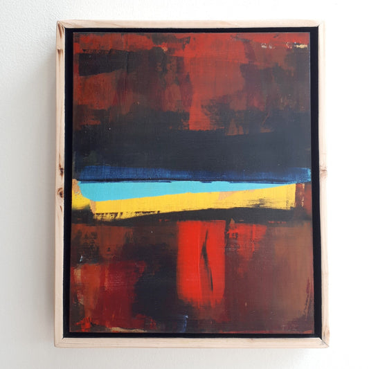 Abstract painting with red, blue, orange and yellow colors framed in a custom natural wood float frame